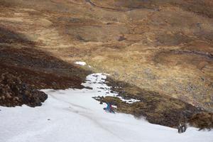 Deep South Gully, Beinn Alligin: Steve Clark following the very helpful tongue of snow out of the mouth of the gully Photo: Scott Muir