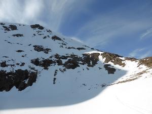 Sputan Main Face, Ben Macdui: Stob Coire Sputan Dearg: Looking back up from the lochan.  Spot the skier in the short gully below the ridge (in the sunlight)  Photo: Scott Muir